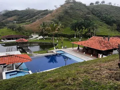 a resort with a swimming pool and a mountain at Finca El Saladero in Ebéjico