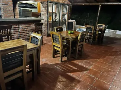 a wooden table and chairs on a patio at Finca El Saladero in Ebéjico