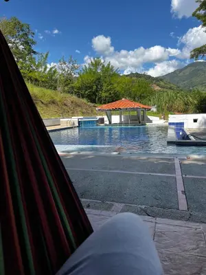 a swimming pool with a gazebo next to it at Finca El Saladero in Ebéjico
