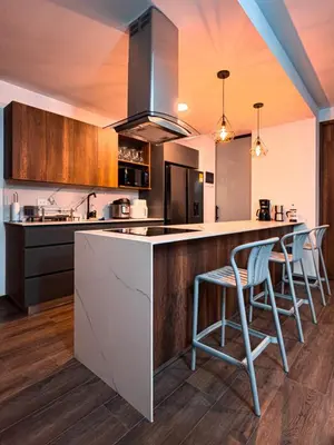 a kitchen with a counter with stools in it at Luxury Country Suite in Retiro, Antioquia in El Retiro