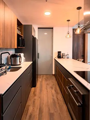 a large kitchen with wooden floors and a counter top at Luxury Country Suite in Retiro, Antioquia in El Retiro