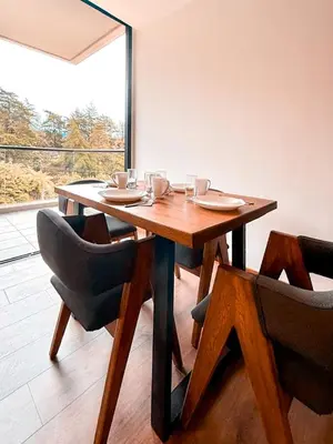 a dining room table with two chairs and a table and a window at Luxury Country Suite in Retiro, Antioquia in El Retiro
