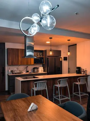 a kitchen with a wooden counter top and a table at Luxury Country Suite in Retiro, Antioquia in El Retiro