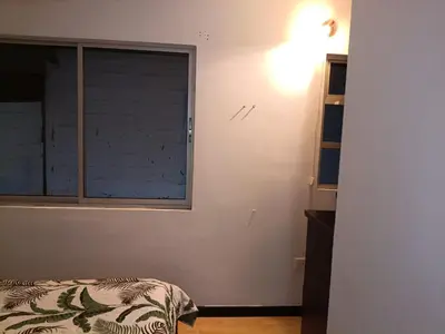 a bedroom with a window and a bed in it at Ninfa del Mar Hostal Turístico in Manizales
