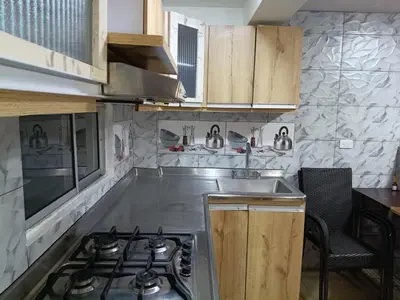 a kitchen with a stove and a sink at Ninfa del Mar Hostal Turístico in Manizales