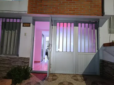 an open door to a building with pink lighting at Ninfa del Mar Hostal Turístico in Manizales