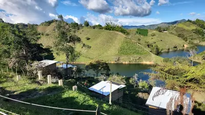 a view of a body of water with hills at Glamping con vista de lujo in Guatapé