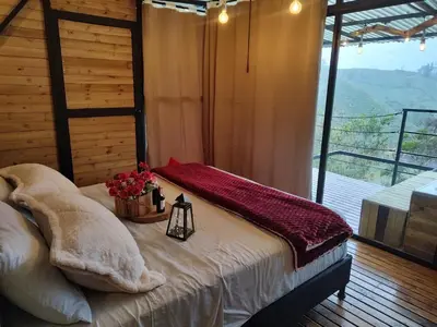a bedroom with a bed with flowers on it at Glamping con vista de lujo in Guatapé