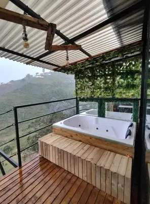 a bath tub on a wooden deck with a view at Glamping con vista de lujo in Guatapé
