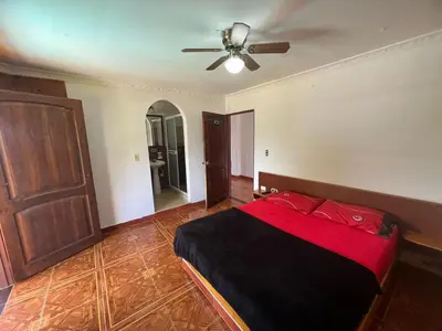 a bedroom with a bed and a ceiling fan at Finca villa mia in Girardota