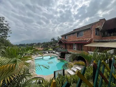 a large swimming pool in front of a building at Finca villa mia in Girardota