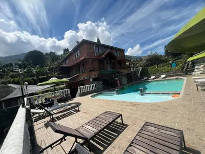 a house with a swimming pool and some chairs at Finca villa mia in Girardota