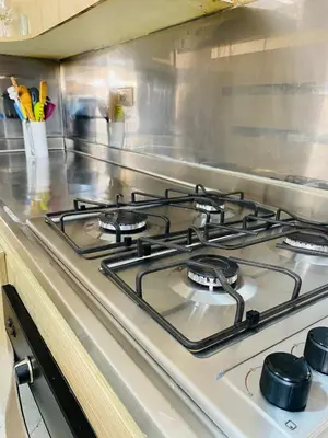 a stove top with four burners in a kitchen at Apartamento comodo, 3 Hab, cerca Poblado in Medellín