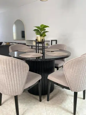 a group of tables and chairs with a potted plant at Apartamento comodo, 3 Hab, cerca Poblado in Medellín