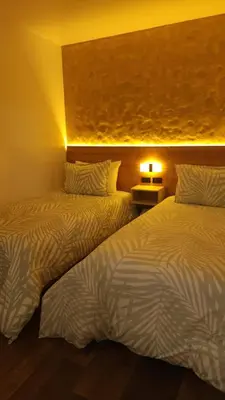 two beds sitting next to each other in a room at Hotel Boutique Paraíso Plaza Aguadas in Aguadas
