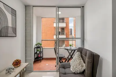 a living room with a couch and a table at 804- APTO 3BR a Pasos del Parque de Sabaneta in Sabaneta
