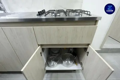 a kitchen drawer with a stove and pots and pans at Luzor Apartments in Medellín