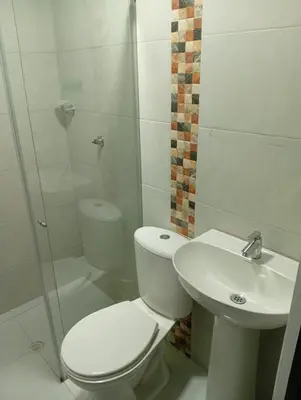 a bathroom with a toilet and a sink and a shower at Nápoles city in Medellín