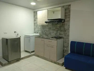 a kitchen with a sink and a stove and a refrigerator at Nápoles city in Medellín