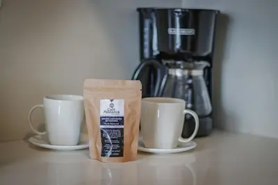 two coffee cups on a counter next to a coffee maker at Luxury Studio El Poblado City View 7th Floor in Medellín
