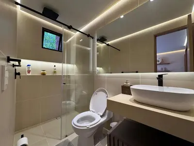 a bathroom with a sink and a toilet and a shower at Arroyuelos in Estación El Salto