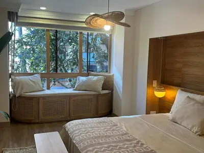 a bedroom with two beds and a large window at Arroyuelos in Estación El Salto
