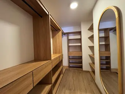 a walk in closet with wooden shelves and a mirror at Arroyuelos in Estación El Salto