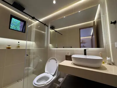 a bathroom with a toilet and a sink and a mirror at Arroyuelos in Estación El Salto