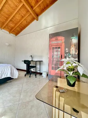 a bedroom with a phone booth and a table at Private room Laureles, Estadio, la 70 Fast WIFI in Medellín