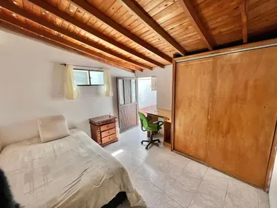 a bedroom with a bed and a desk and a chair at Private room Laureles, Estadio, la 70 Fast WIFI in Medellín
