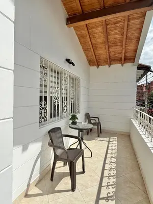 a patio with chairs and a table on a building at Private room Laureles, Estadio, la 70 Fast WIFI in Medellín