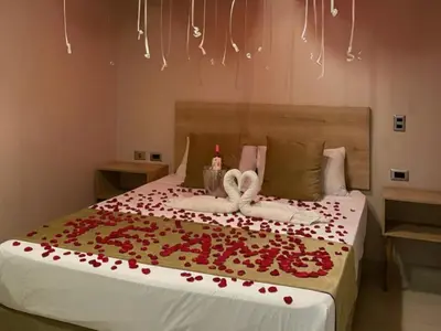 a bedroom with a bed with red roses on it at Hotel, Villa Real,Medellín ,Laureles,Estadio in Medellín
