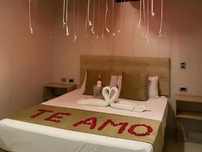 a bedroom with a bed with two towels on it at Hotel, Villa Real,Medellín ,Laureles,Estadio in Medellín