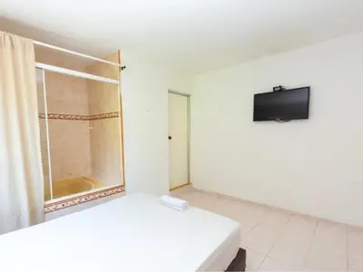 a white room with a tv on a wall at Hotel, Villa Real,Medellín ,Laureles,Estadio in Medellín