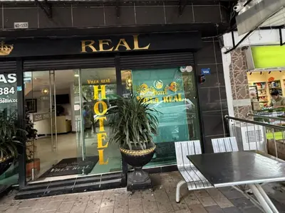 a store window with a potted plant in front of it at Hotel, Villa Real,Medellín ,Laureles,Estadio in Medellín