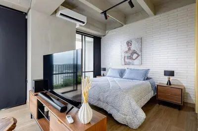 a bedroom with a bed and a large window at DISTRITO v in Estación El Salto