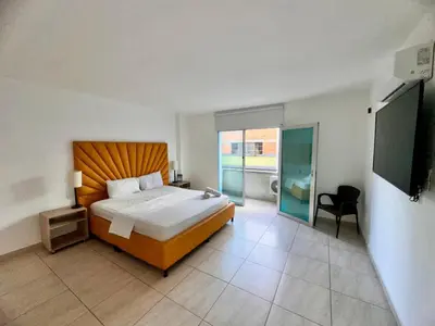 a bedroom with a bed and a television in it at Hotel Opera Medellín Entertainment, Adults Only in Medellín