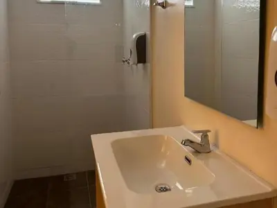 a bathroom with a sink and a mirror and a shower at Hotel Opera Medellín Entertainment, Adults Only in Medellín