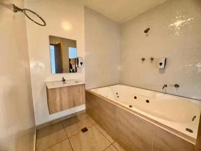 a white bathroom with a tub and a sink at Hotel Opera Medellín Entertainment, Adults Only in Medellín