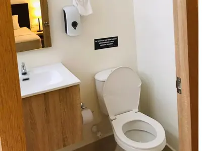a bathroom with a toilet and a sink at Hotel Opera Medellín Entertainment, Adults Only in Medellín