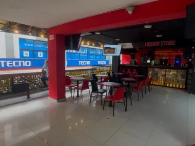a bar with tables and chairs in a restaurant at Hotel Opera Medellín Entertainment, Adults Only in Medellín