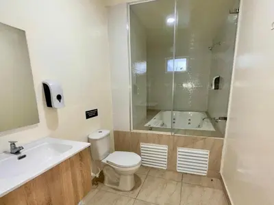 a bathroom with a toilet and a sink and a shower at Hotel Opera Medellín Entertainment, Adults Only in Medellín