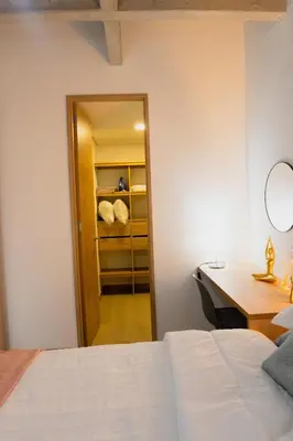 a bedroom with a bed and a desk and a mirror at Incredible new apartment in Envigado for six people in Envigado