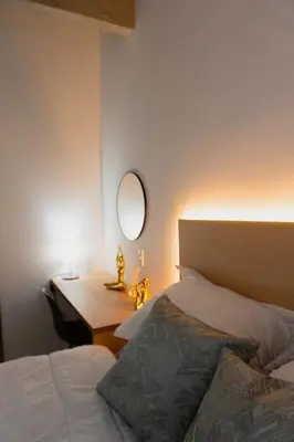 a bedroom with a bed and a desk with a mirror at Incredible new apartment in Envigado for six people in Envigado