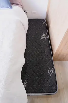 a black rug on the floor next to a bed at Incredible new apartment in Envigado for six people in Envigado