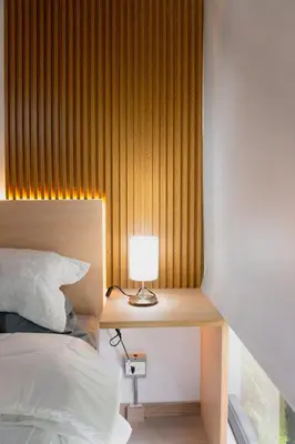 a bedroom with a bed and a table with a lamp at Incredible new apartment in Envigado for six people in Envigado