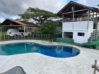 a small swimming pool in front of a house at Hotel Montañitas in Guatapé