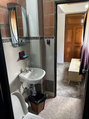 a bathroom with a sink and a mirror at Hotel Montañitas in Guatapé