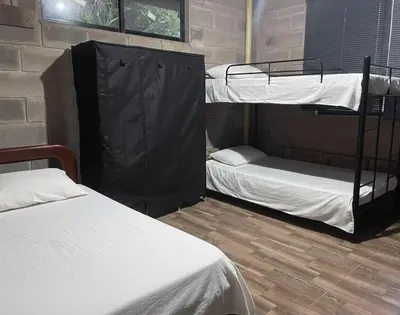 a room with two bunk beds in a building at Casa Finca cerca al embalse Jaguas San Roque Antioquia