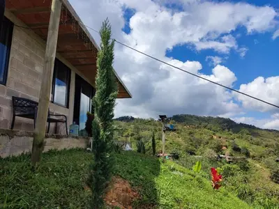 a house with a view of a mountain at Casa Finca cerca al embalse Jaguas San Roque Antioquia